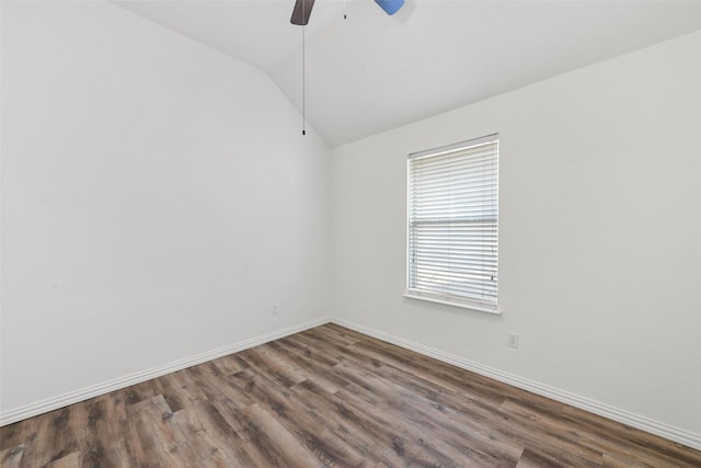 empty room featuring wood finished floors, baseboards, ceiling fan, and vaulted ceiling