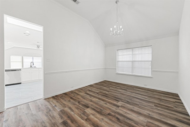 unfurnished dining area with vaulted ceiling, a chandelier, a sink, wood finished floors, and crown molding