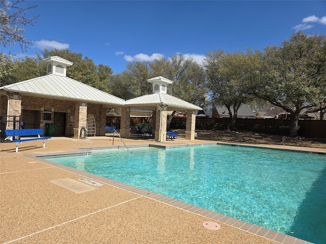 community pool featuring a gazebo, a patio area, and fence