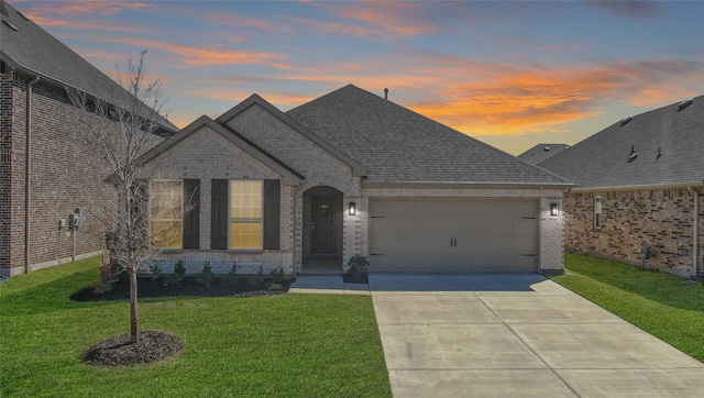 3954 Brangus Dr, Mckinney, TX 75071 - french country home featuring a garage, brick siding, a front yard, and concrete driveway