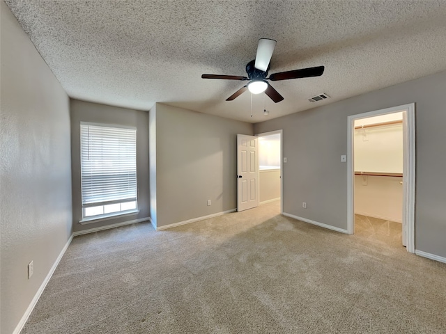 1114 Huntington Trl, Mansfield, TX 76063 - unfurnished bedroom with a spacious closet, visible vents, carpet flooring, and baseboards