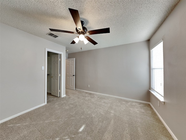 1114 Huntington Trl, Mansfield, TX 76063 - unfurnished bedroom featuring visible vents, light carpet, a textured ceiling, and baseboards