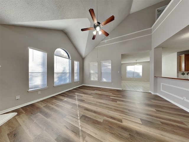 1114 Huntington Trl, Mansfield, TX 76063 - unfurnished room featuring plenty of natural light, a textured ceiling, ceiling fan, and wood finished floors