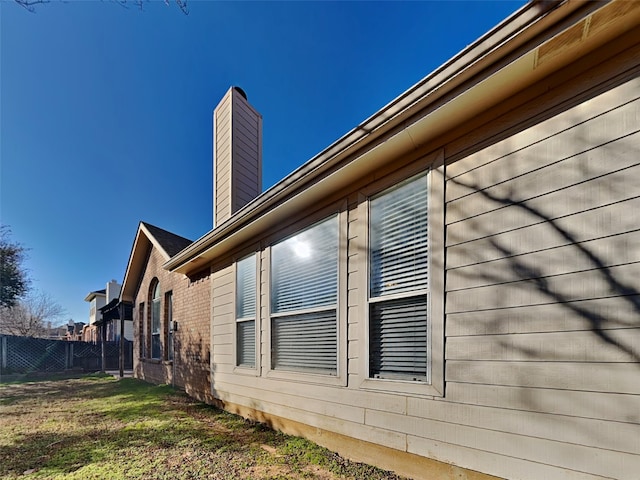 1114 Huntington Trl, Mansfield, TX 76063 - view of side of home with a yard, a chimney, and fence