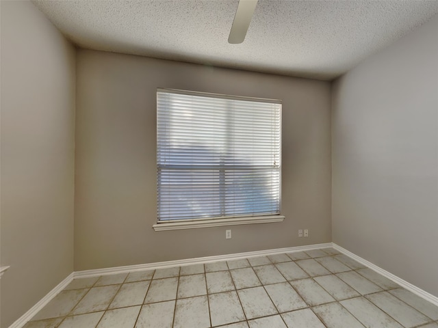 1114 Huntington Trl, Mansfield, TX 76063 - empty room with a textured ceiling, light tile patterned flooring, baseboards, and ceiling fan