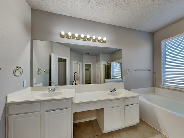 1114 Huntington Trl, Mansfield, TX 76063 - full bath featuring a sink, a garden tub, double vanity, and a textured ceiling
