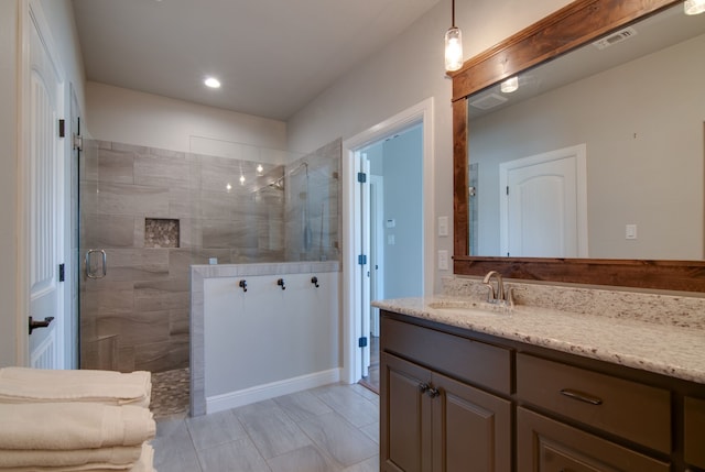 full bath featuring vanity, recessed lighting, and walk in shower