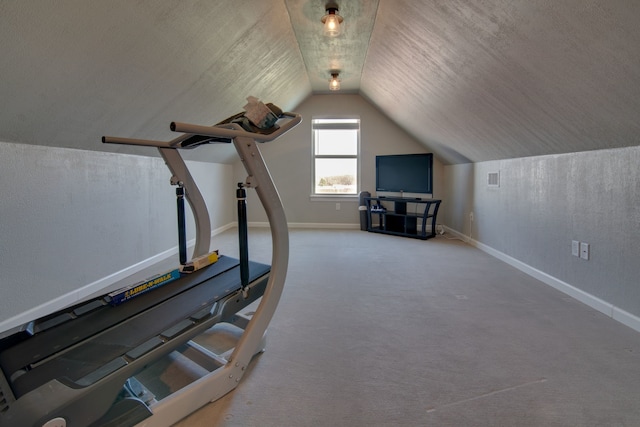 workout room featuring carpet flooring, baseboards, vaulted ceiling, and visible vents