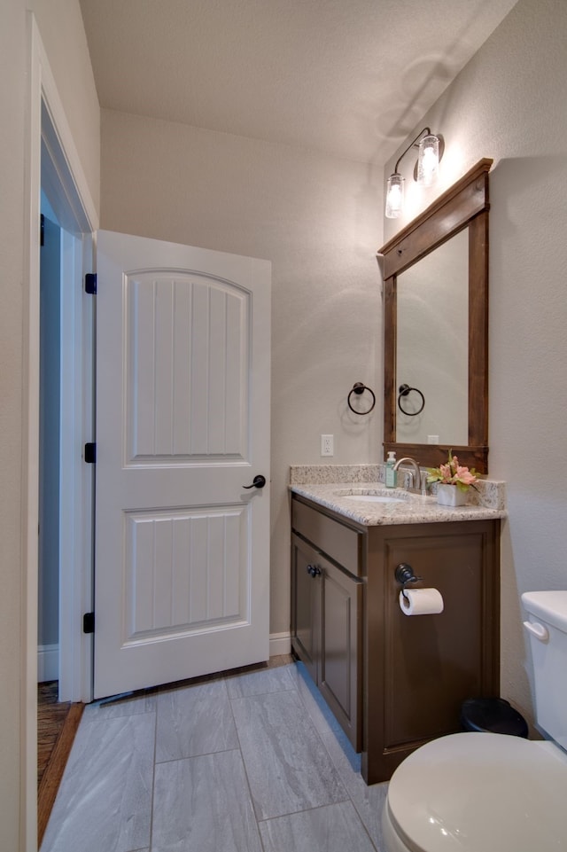 bathroom featuring toilet and vanity