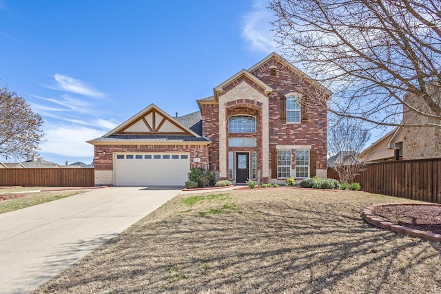 traditional home with fence, concrete driveway, brick siding, and an attached garage