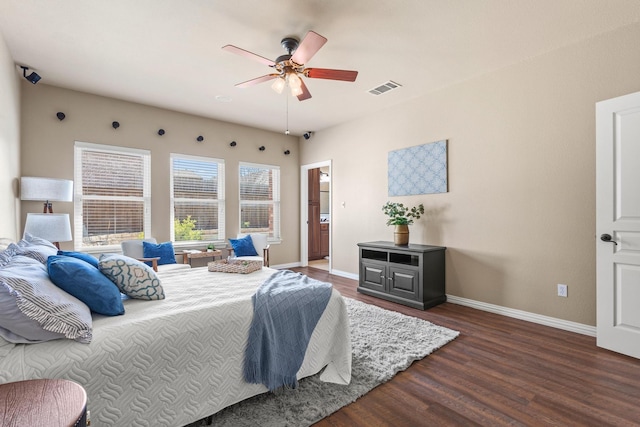 bedroom with visible vents, ceiling fan, wood finished floors, and baseboards