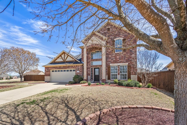 traditional-style home with fence, an attached garage, driveway, and brick siding