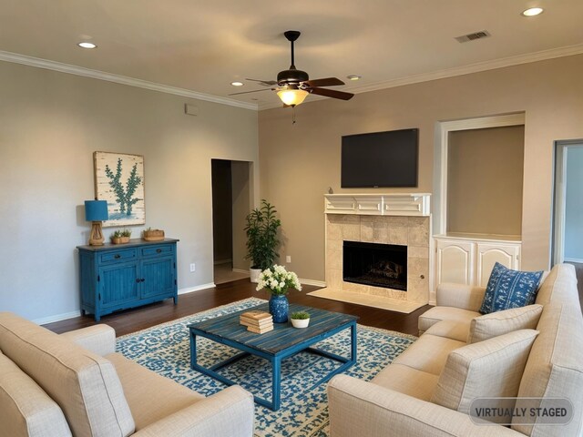 2449 Elm Leaf Ln, Plano, TX 75025 - living room with wood finished floors, ceiling fan, baseboards, a tile fireplace, and ornamental molding