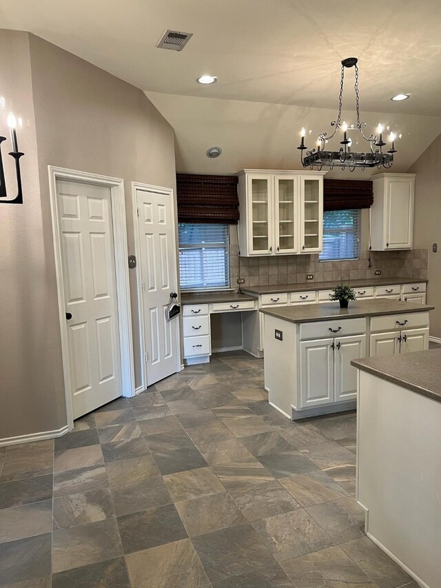 2449 Elm Leaf Ln, Plano, TX 75025 - kitchen with a chandelier, glass insert cabinets, tasteful backsplash, white cabinets, and recessed lighting