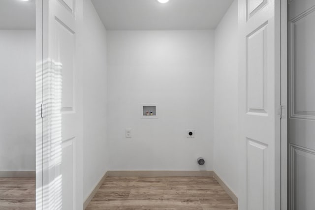 4726 Bartlett Ave, Dallas, TX 75216 - washroom with electric dryer hookup, washer hookup, light wood finished floors, and baseboards