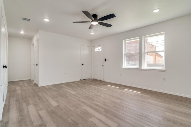 1105 E 1st N St, Kaufman, TX 75142 - unfurnished living room featuring ceiling fan, baseboards, visible vents, and light wood-type flooring