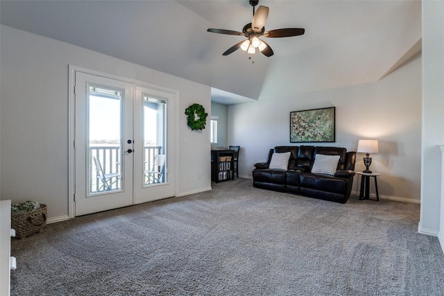 carpeted living area with ceiling fan, vaulted ceiling, french doors, and baseboards