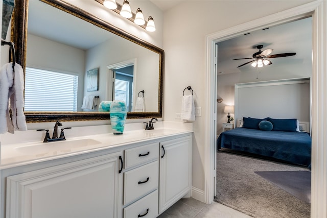 ensuite bathroom with ensuite bath, a ceiling fan, a sink, and double vanity
