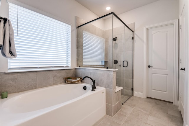 full bathroom with a bath, tile patterned floors, and a stall shower