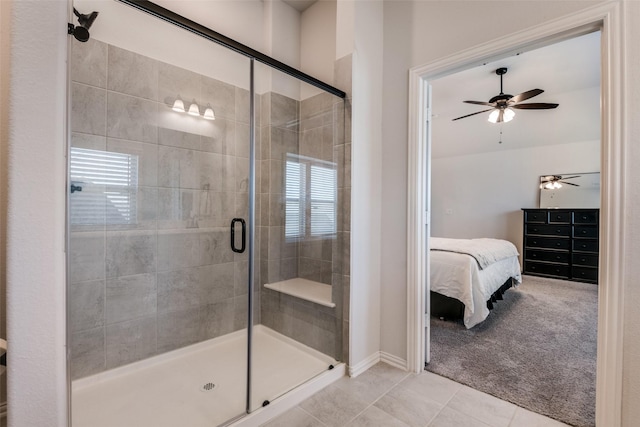 ensuite bathroom with a shower stall, a ceiling fan, baseboards, and connected bathroom