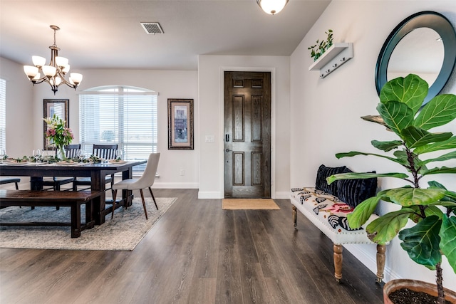 dining area with a chandelier, visible vents, baseboards, and dark wood-style flooring