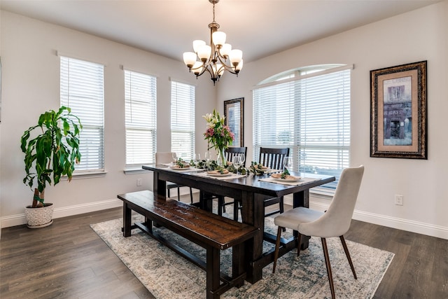 dining room featuring baseboards, a chandelier, and dark wood-style floors