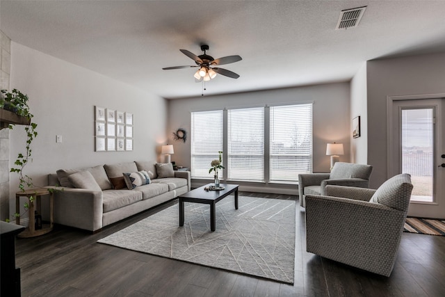 living room featuring a ceiling fan, wood finished floors, and visible vents