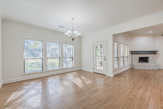 10471 Holly Creek Rd, Poetry, TX 75160 - unfurnished living room with light wood-style flooring, a notable chandelier, a fireplace, and visible vents