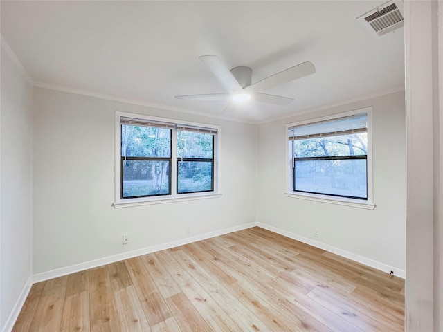 empty room featuring baseboards, visible vents, a ceiling fan, and hardwood / wood-style flooring