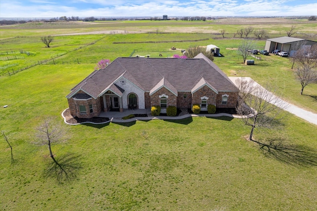 birds eye view of property with a rural view