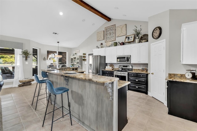 4933 County Road 340, Mckinney, TX 75071 - kitchen with light tile patterned floors, visible vents, beam ceiling, and appliances with stainless steel finishes