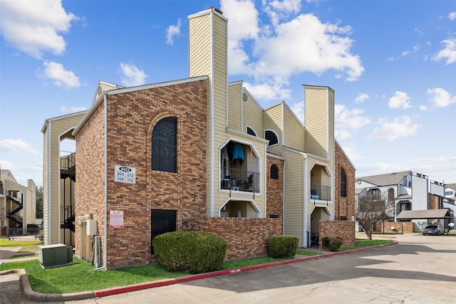 view of building exterior with a residential view and central AC
