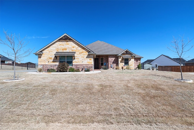 view of front of home with fence and stone siding