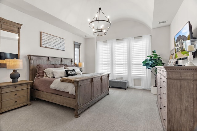 bedroom featuring an inviting chandelier, light colored carpet, visible vents, and lofted ceiling