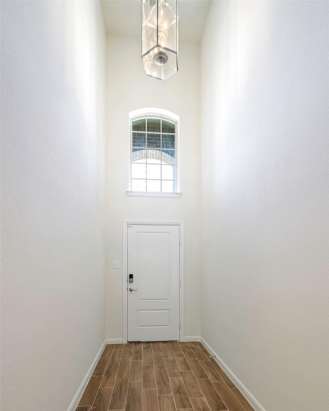 405 Waterton Dr, Anna, TX 75409 - doorway to outside with baseboards, dark wood-type flooring, and a towering ceiling
