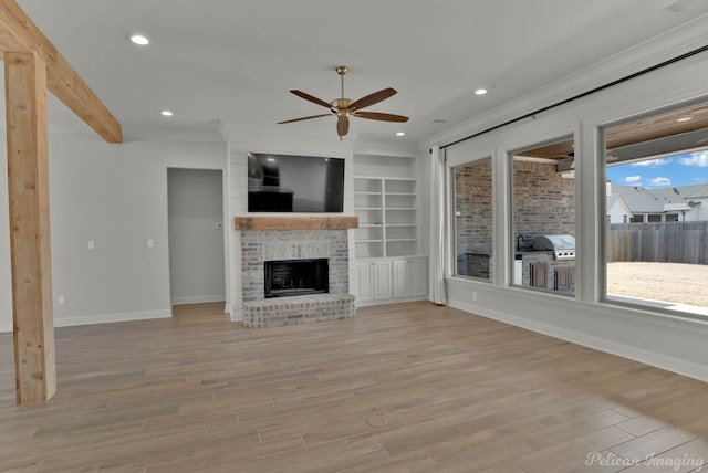unfurnished living room with baseboards, recessed lighting, light wood-style flooring, a fireplace, and a ceiling fan