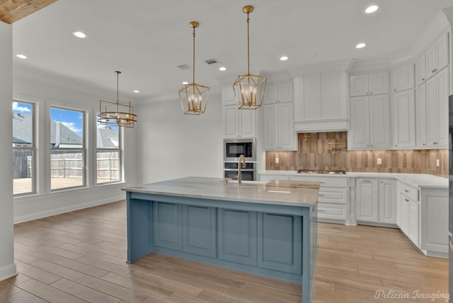 kitchen featuring tasteful backsplash, a notable chandelier, stainless steel appliances, and premium range hood
