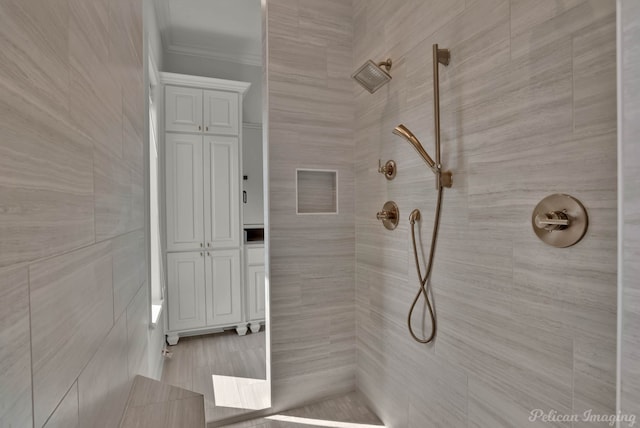 full bath with crown molding and a tile shower