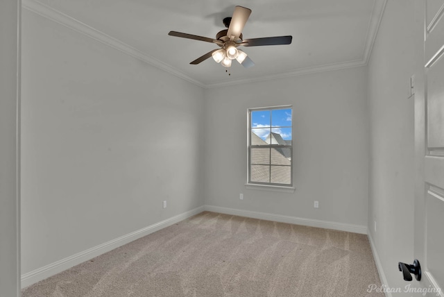 spare room with light colored carpet, a ceiling fan, crown molding, and baseboards