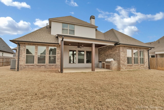back of property with brick siding, a fenced backyard, a patio area, and a ceiling fan