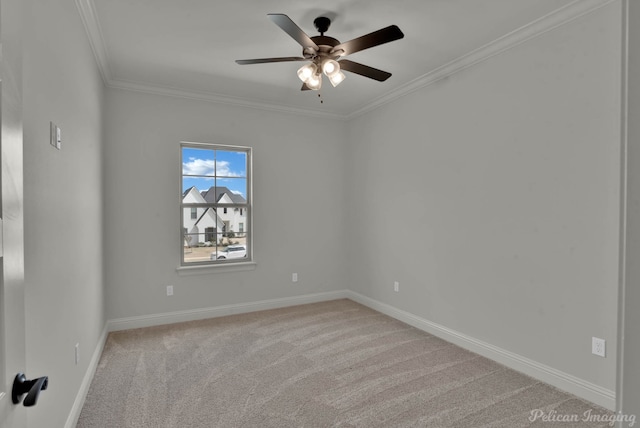 carpeted spare room featuring baseboards, crown molding, and ceiling fan