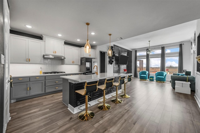 7436 Whisterwheel Way, Fort Worth, TX 76123 - kitchen with stainless steel gas cooktop, gray cabinetry, light countertops, smart refrigerator, and under cabinet range hood