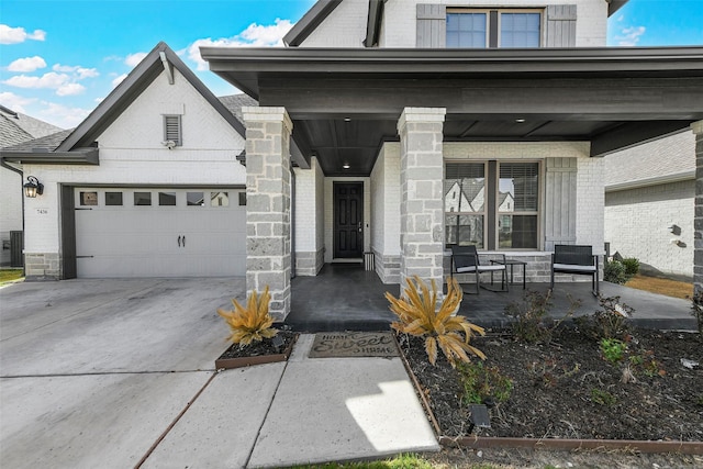 7436 Whisterwheel Way, Fort Worth, TX 76123 - view of front of home with covered porch, concrete driveway, a garage, stone siding, and brick siding