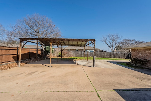 view of patio / terrace featuring a detached carport, a fenced backyard, and a pergola