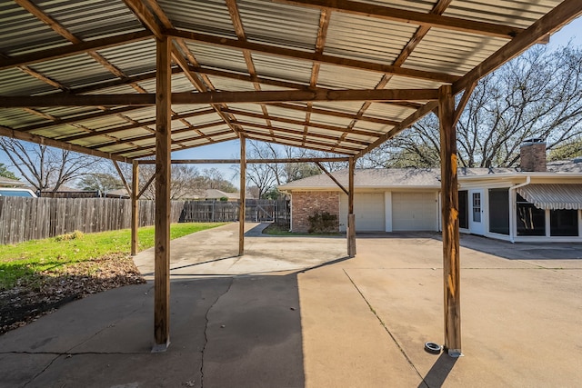 view of patio featuring a garage and fence