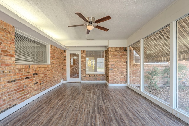 unfurnished sunroom featuring visible vents and ceiling fan