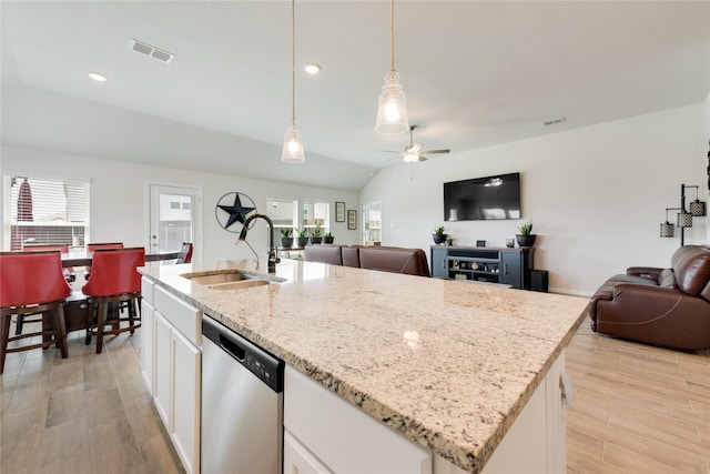 kitchen with a ceiling fan, a sink, open floor plan, white cabinetry, and dishwasher