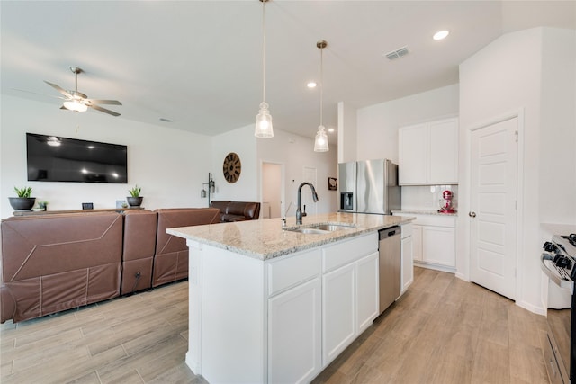 kitchen with visible vents, light wood-style flooring, a sink, appliances with stainless steel finishes, and open floor plan