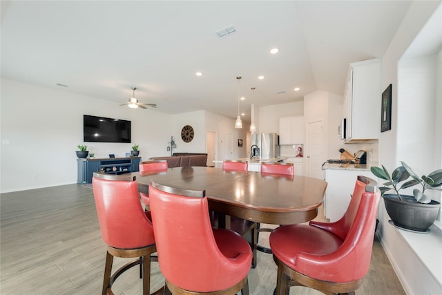 dining area featuring visible vents, a ceiling fan, recessed lighting, light wood-style floors, and baseboards