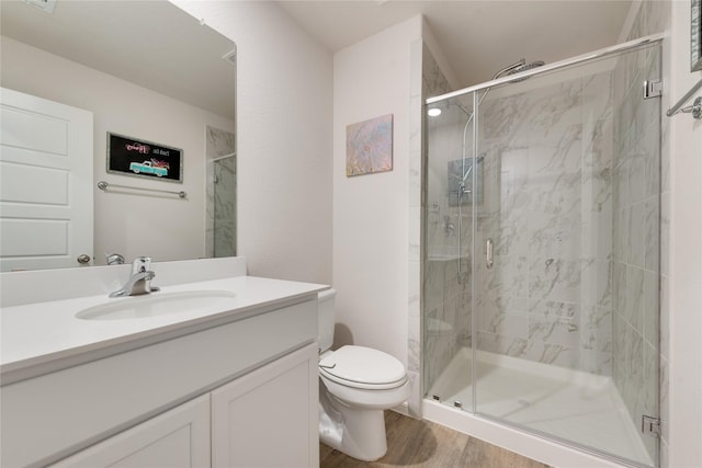 bathroom featuring vanity, toilet, and a marble finish shower